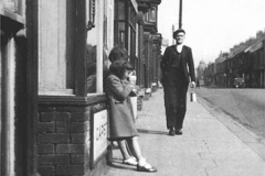 Front Street, early 1960s:Henry Saxby "coming home from the pit" past McCartney's (later Bell's Paper Shop)