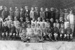 Infants E54 1928 - J Dowding, W Walker, L Hall, J Spence, C Williams, T Smith, E Mason, D Thompson, ? Williamson, Miss Lovett Girls:  S Tipling, P Whiteman, ? Kellett, ? Camiss, M Bradshaw L Hammond, ? Burnside, M Handley, J Lamb, C Andrewatha, T Venables, E Furey, E Williams